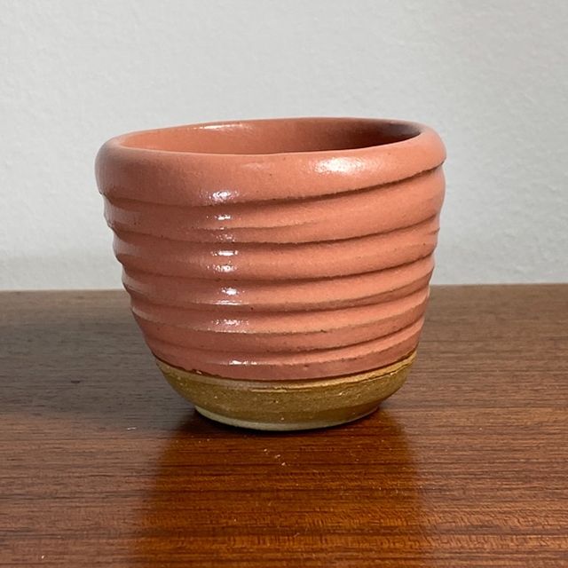 Pink teacup with incised horizontal lines