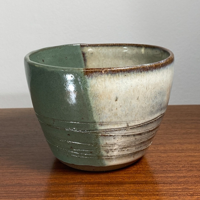Incised vulcan clay pot with two-tone glaze
